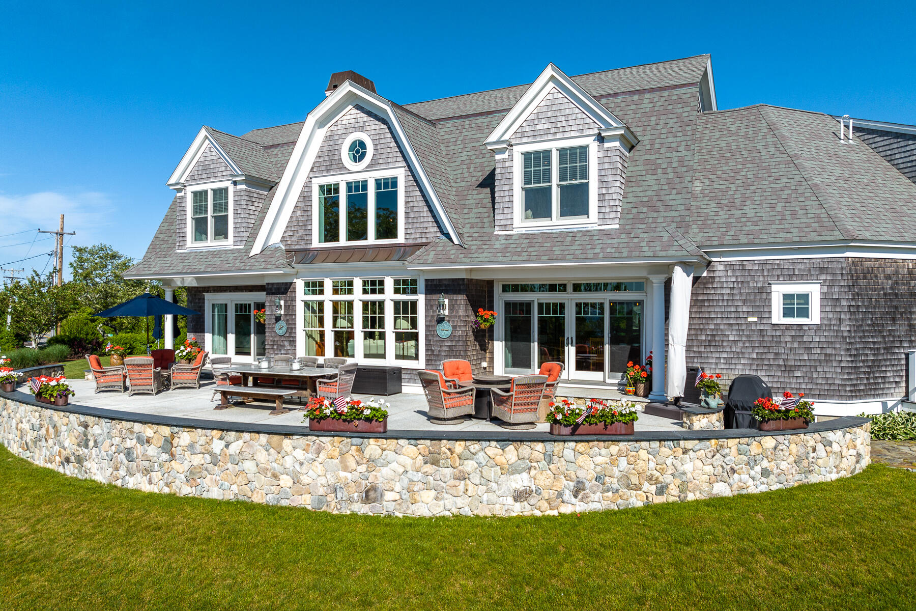 345 Robbins Hill Road Brewster, MA 02631 - Photo 4 of 95 a front view of a house with swimming pool and furniture
