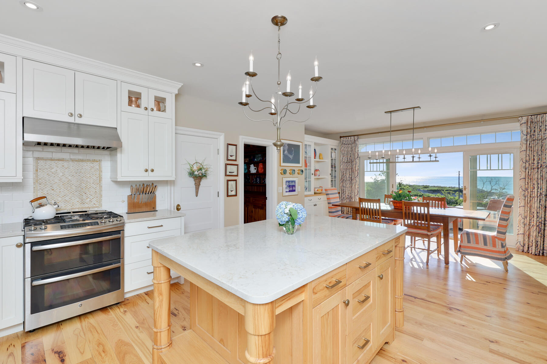 345 Robbins Hill Road Brewster, MA 02631 - Photo 46 of 95 a kitchen with kitchen island a stove a table and chairs in it