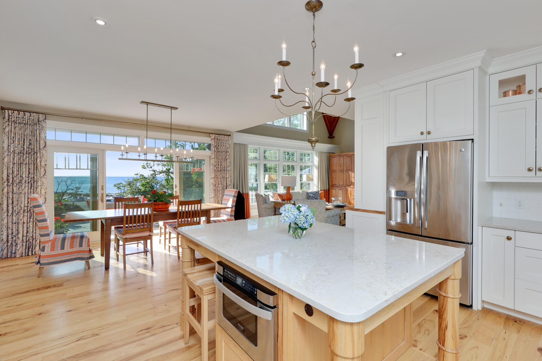 345 Robbins Hill Road Brewster, MA 02631 - Photo 47 of 95 a view of a dining room and livingroom with furniture wooden floor a chandelier