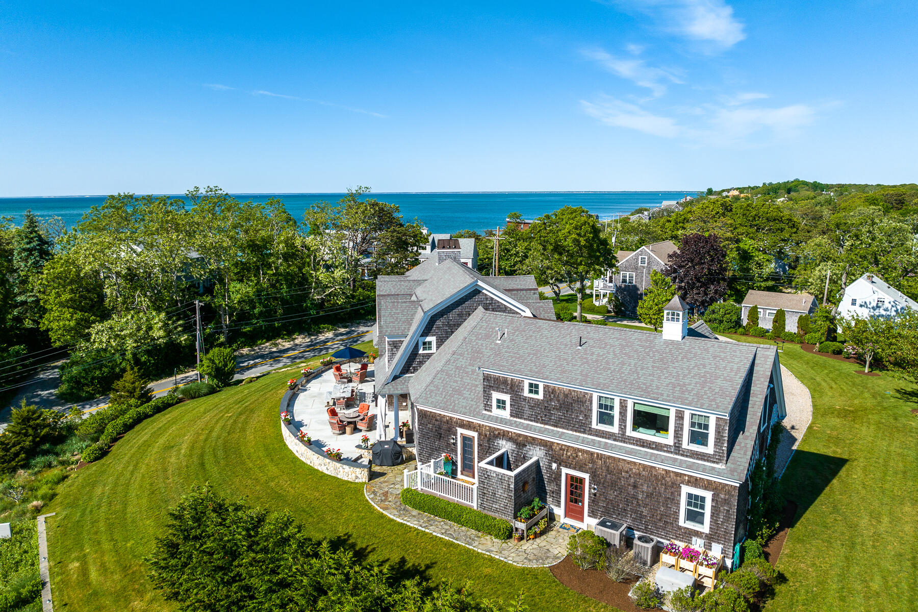 345 Robbins Hill Road Brewster, MA 02631 - Photo 10 of 95 an aerial view of a house with a garden and lake view