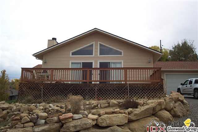 650 Moki Avenue Rifle, CO 81650 - Photo 2 of 4 a front view of a house with a yard