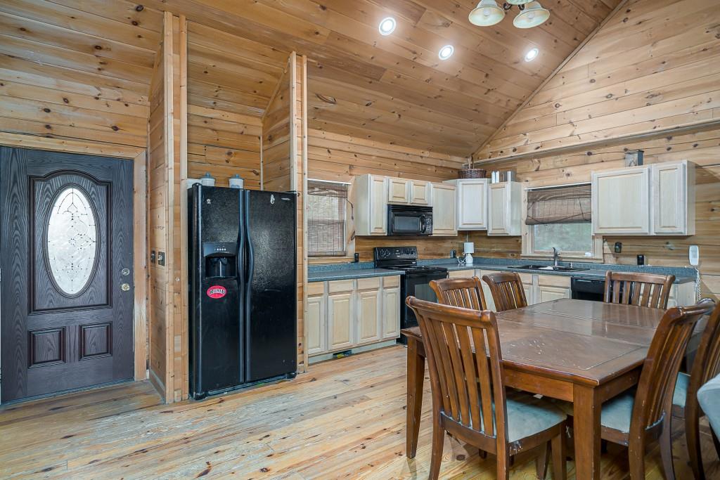 124 Adair Drive Ranger, GA 30734 - Photo 8 of 25 a kitchen with stainless steel appliances granite countertop a stove refrigerator a microwave oven with a dining table and chairs