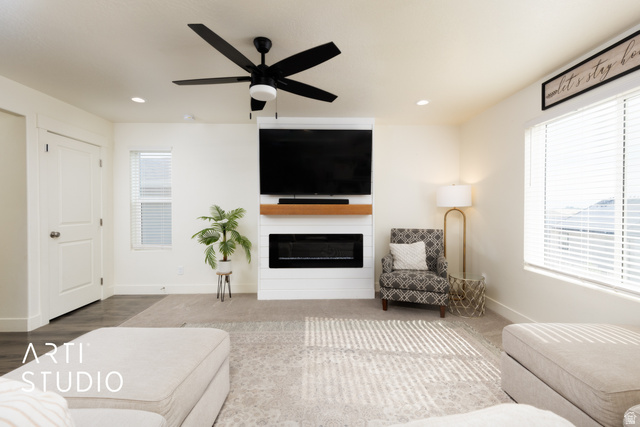 1713 South Windemere Road Santaquin, UT 84655 - Photo 7 of 40 Living area featuring a floor-to-ceiling media wall with integrated electric fireplace and wood mantle