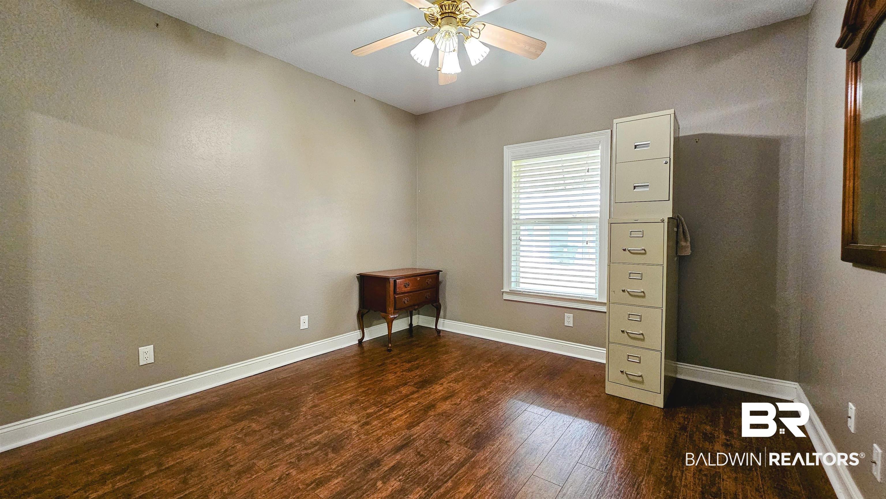9275 Crawford Road Elberta, AL 36530 - Photo 25 of 28 Spare room with dark wood-style flooring and ceiling fan