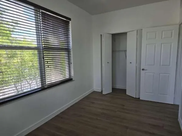 a view of wooden floor and windows in a room