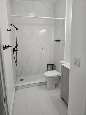 a bathroom with a toilet a sink and shower