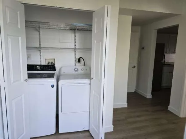 a view of walk in closet with wooden floor