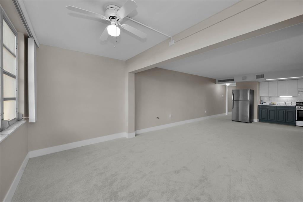 622 Edgewater Drive, Unit 123 Dunedin, FL 34698 - Photo 20 of 46 a view of empty room with a ceiling fan and window