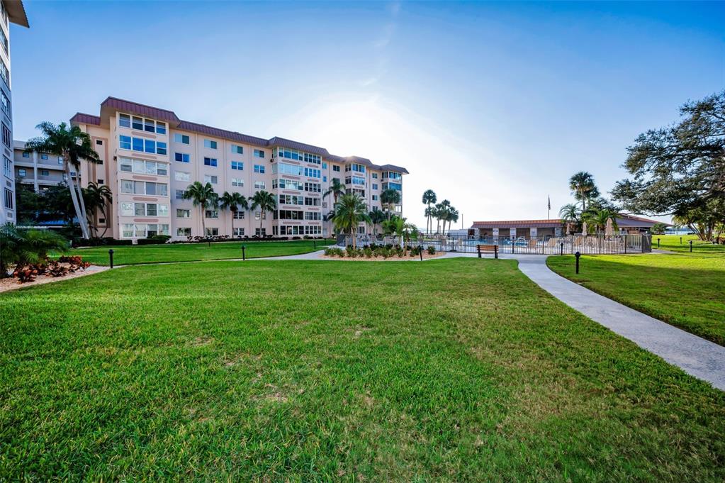 622 Edgewater Drive, Unit 123 Dunedin, FL 34698 - Photo 28 of 46 a view of a building with a yard