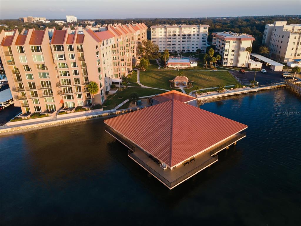 622 Edgewater Drive, Unit 123 Dunedin, FL 34698 - Photo 34 of 46 a blue swimming pool with a outdoor seating