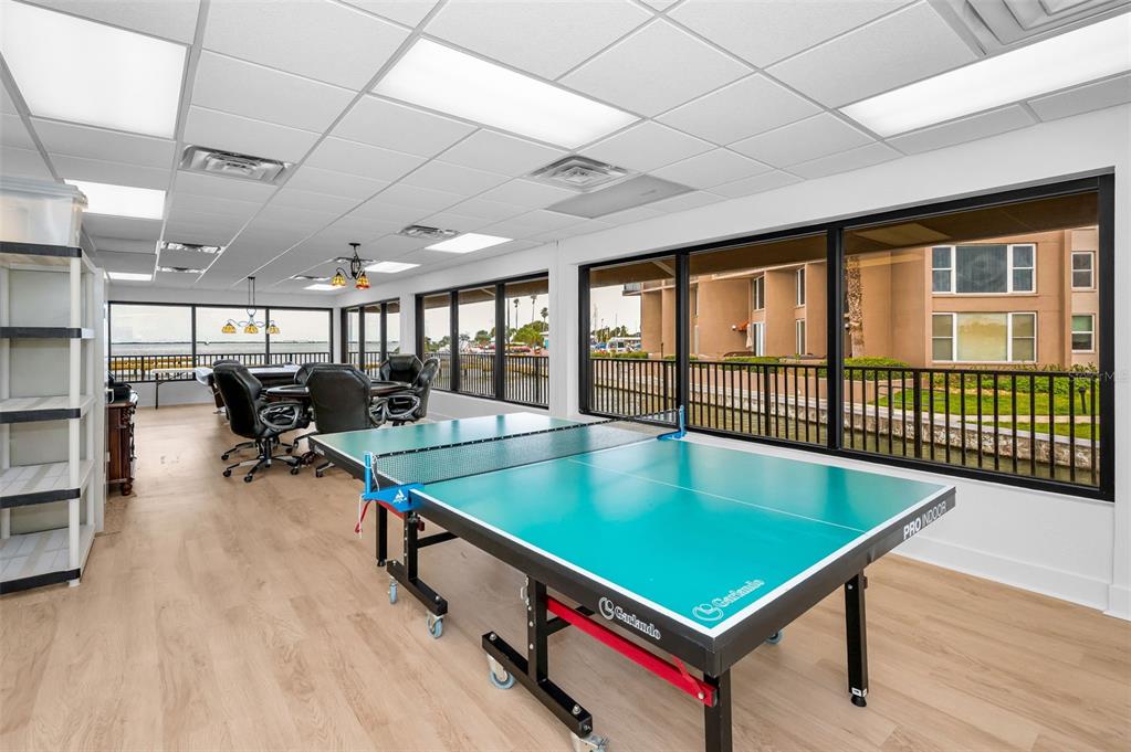 622 Edgewater Drive, Unit 123 Dunedin, FL 34698 - Photo 39 of 46 a room with lots of table tennis table and a large window