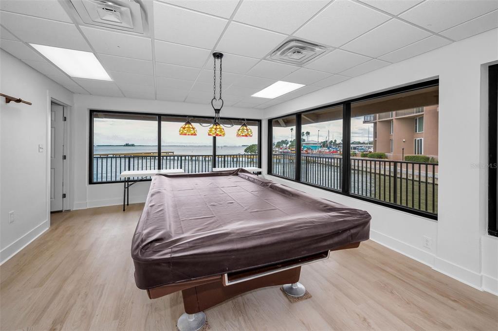 622 Edgewater Drive, Unit 123 Dunedin, FL 34698 - Photo 40 of 46 a bed sitting in a room next to a balcony