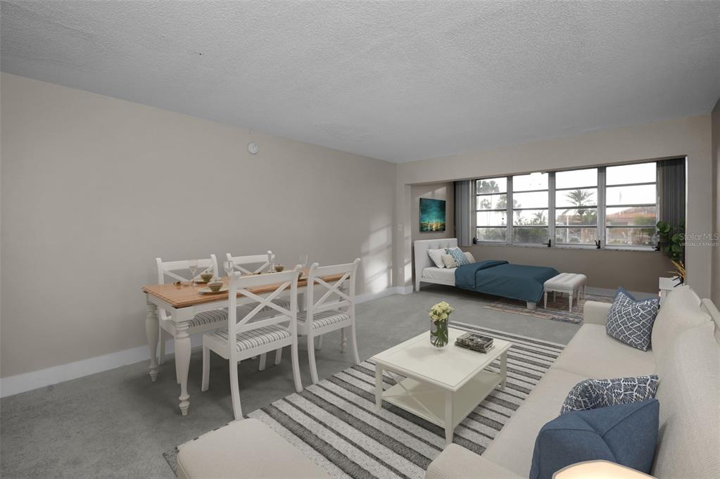 622 Edgewater Drive, Unit 123 Dunedin, FL 34698 - Photo 4 of 46 a living room with furniture and a table