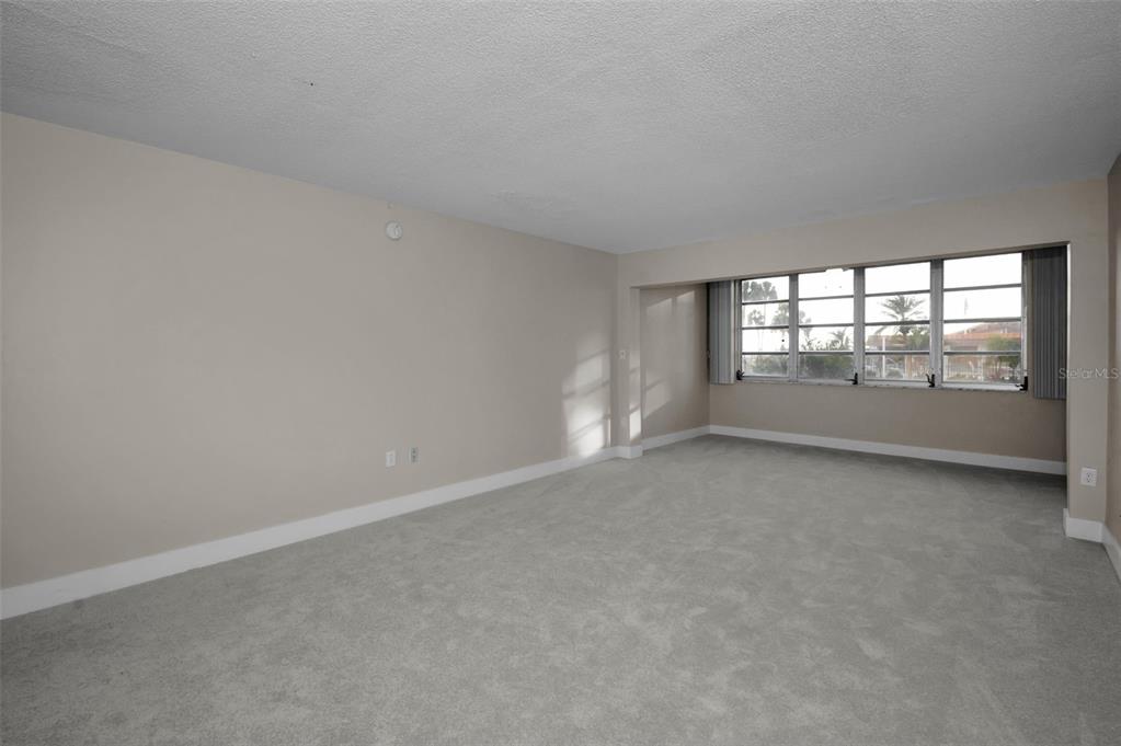 622 Edgewater Drive, Unit 123 Dunedin, FL 34698 - Photo 5 of 46 an empty room with windows