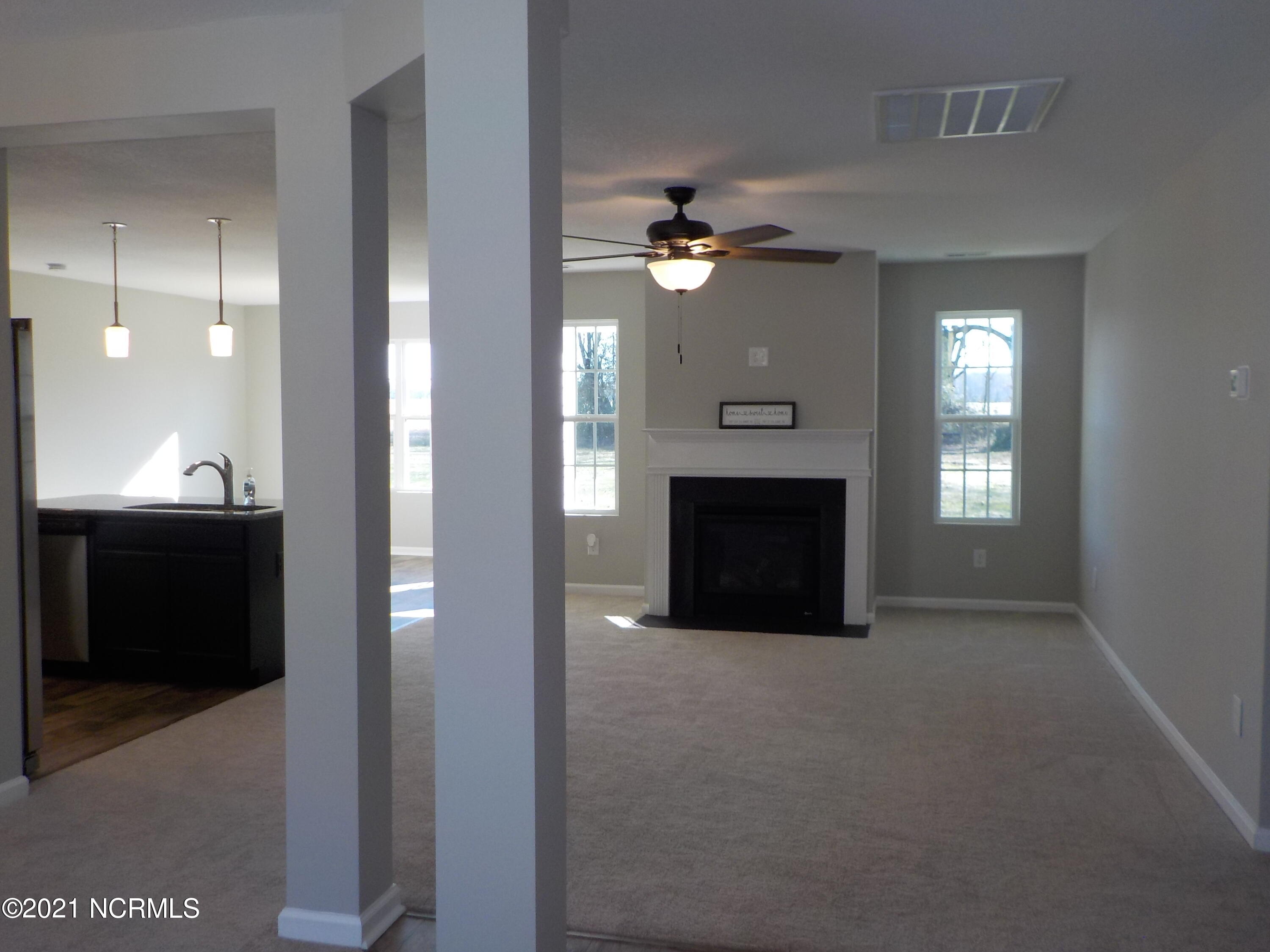 7735 Liles Road Bailey, NC 27807 - Photo 21 of 69 living room with fireplace, gas logs