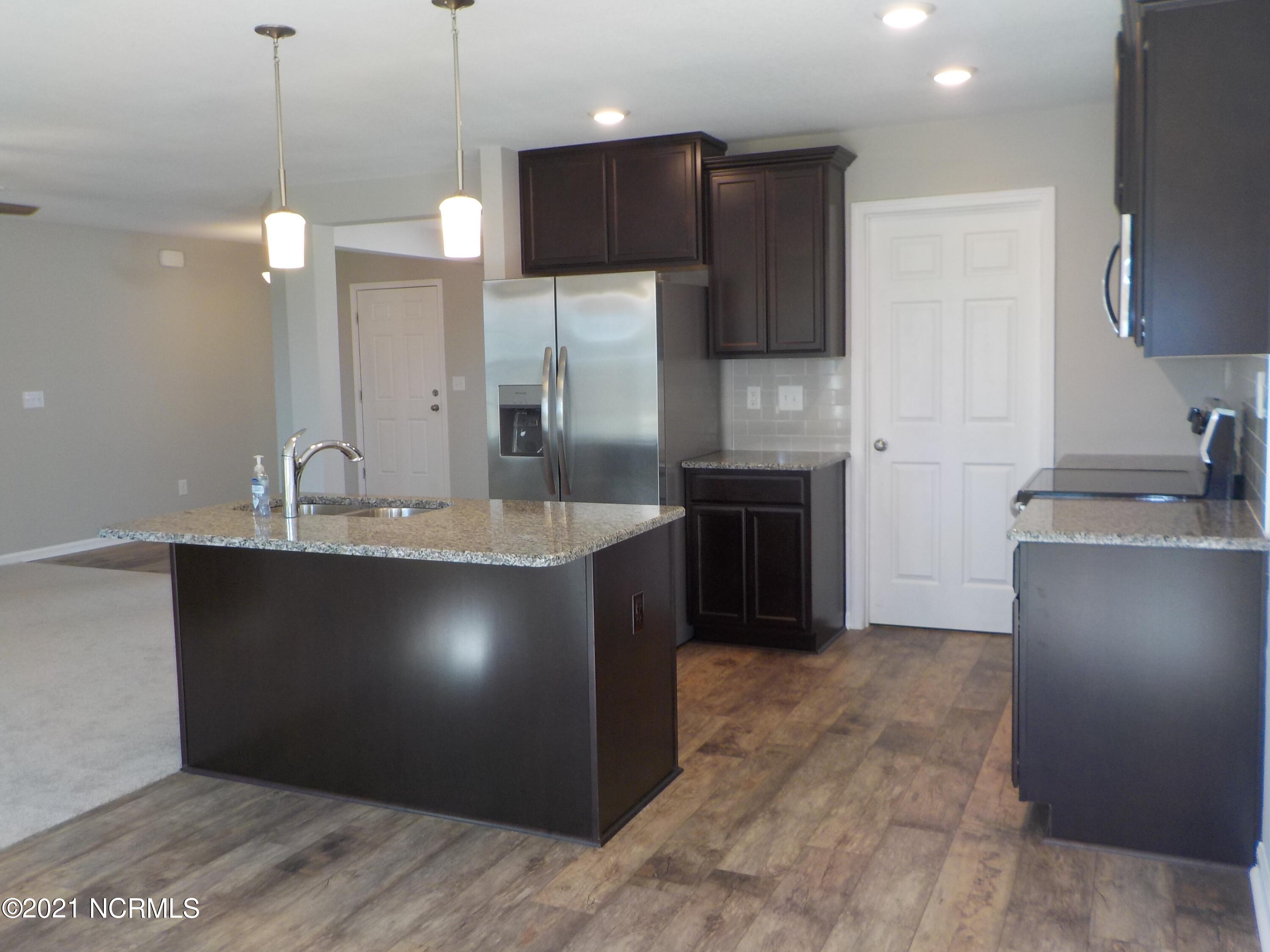 7735 Liles Road Bailey, NC 27807 - Photo 29 of 69 kitchen with custom cabinets, stainless appliance package, LVP flooring