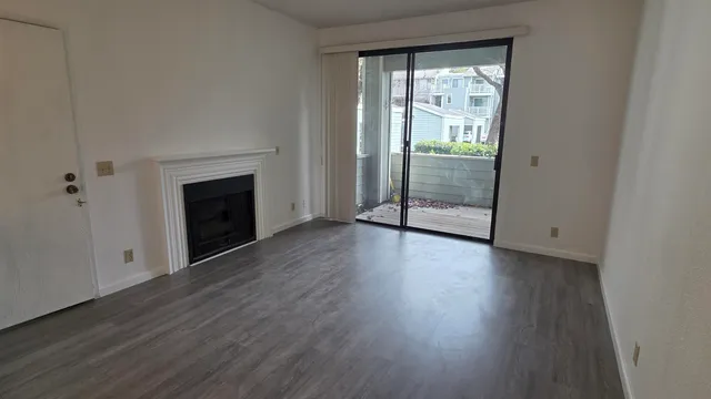wooden floor fireplace and natural light in room