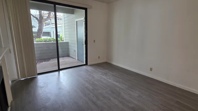 a view of wooden floor and brick walls