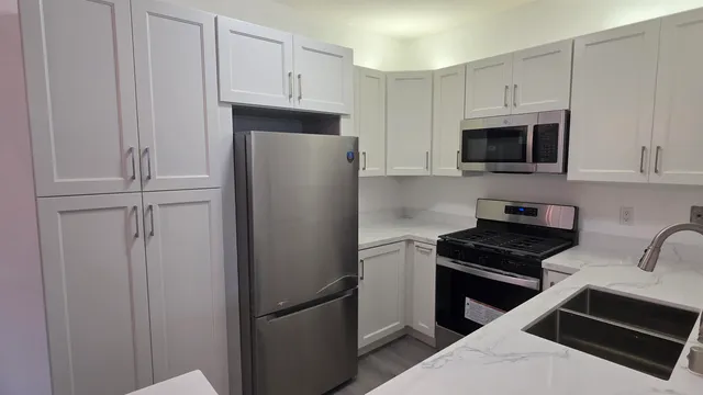 a kitchen with cabinets stainless steel appliances and cabinets