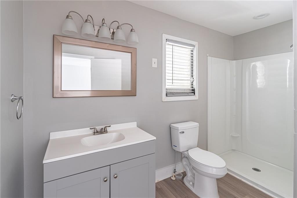 8035 Rockbridge Road Southwest Lithonia, GA 30058 - Photo 16 of 39 a bathroom with a toilet sink and mirror
