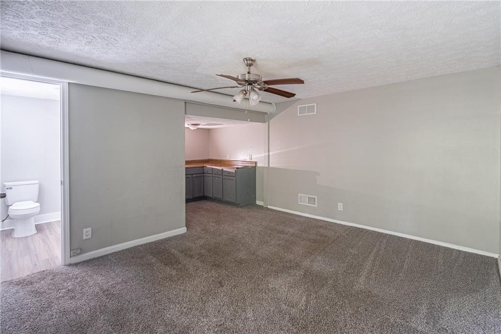 8035 Rockbridge Road Southwest Lithonia, GA 30058 - Photo 18 of 39 wooden floor in an empty room with a bathroom