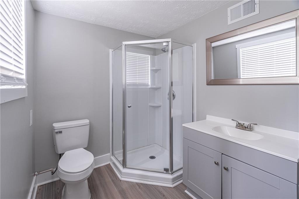 8035 Rockbridge Road Southwest Lithonia, GA 30058 - Photo 21 of 39 a bathroom with a toilet sink and shower