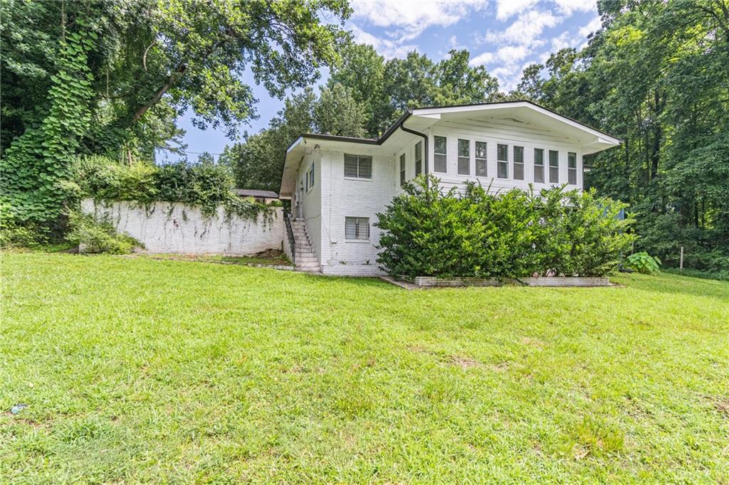 8035 Rockbridge Road Southwest Lithonia, GA 30058 - Photo 23 of 39 a view of a house with backyard and garden