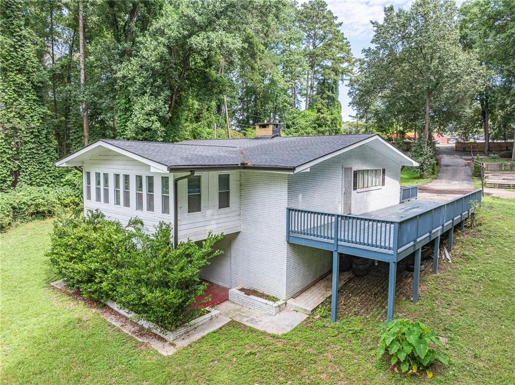 8035 Rockbridge Road Southwest Lithonia, GA 30058 - Photo 24 of 39 a aerial view of a house with a yard table and chairs