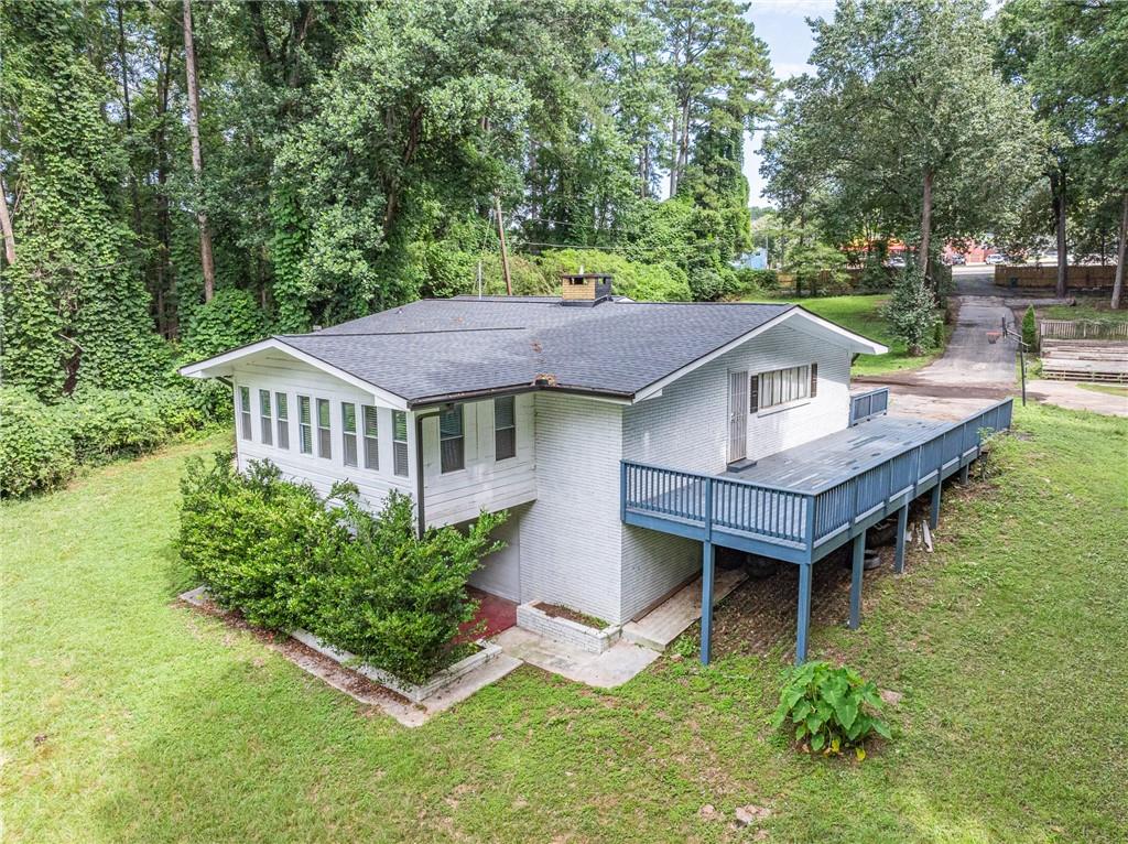 8035 Rockbridge Road Southwest Lithonia, GA 30058 - Photo 25 of 39 a aerial view of a house with swimming pool next to a yard