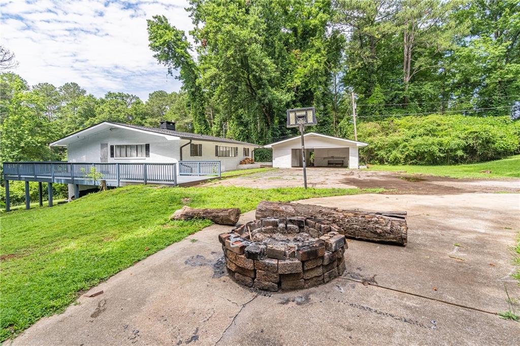 8035 Rockbridge Road Southwest Lithonia, GA 30058 - Photo 3 of 39 a view of a house with a yard and sitting area