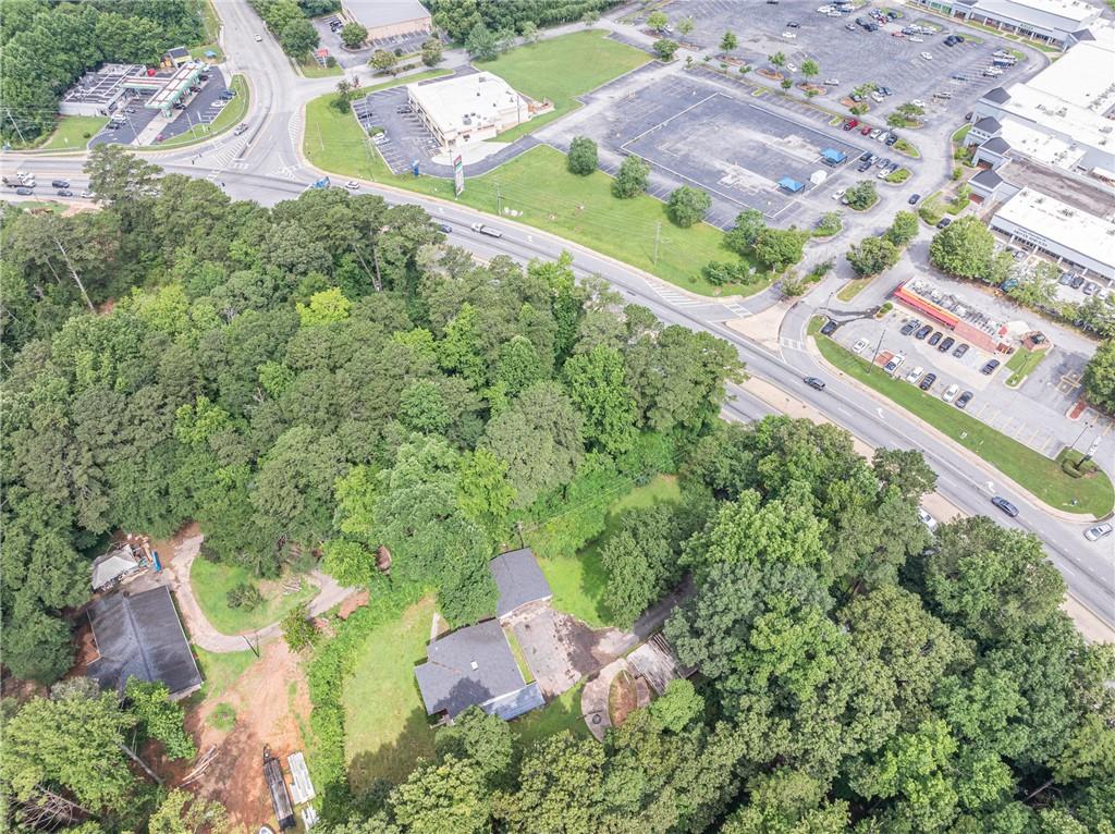8035 Rockbridge Road Southwest Lithonia, GA 30058 - Photo 32 of 39 an aerial view of a house with a yard and greenery