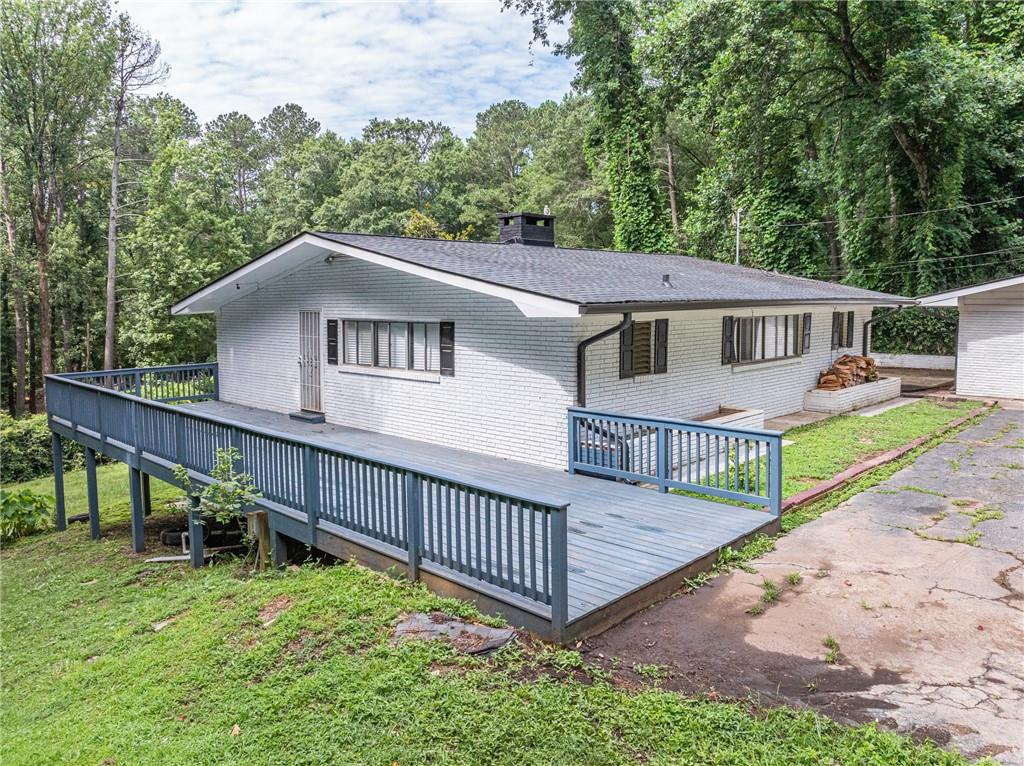 8035 Rockbridge Road Southwest Lithonia, GA 30058 - Photo 4 of 39 a view of house with a yard and pool