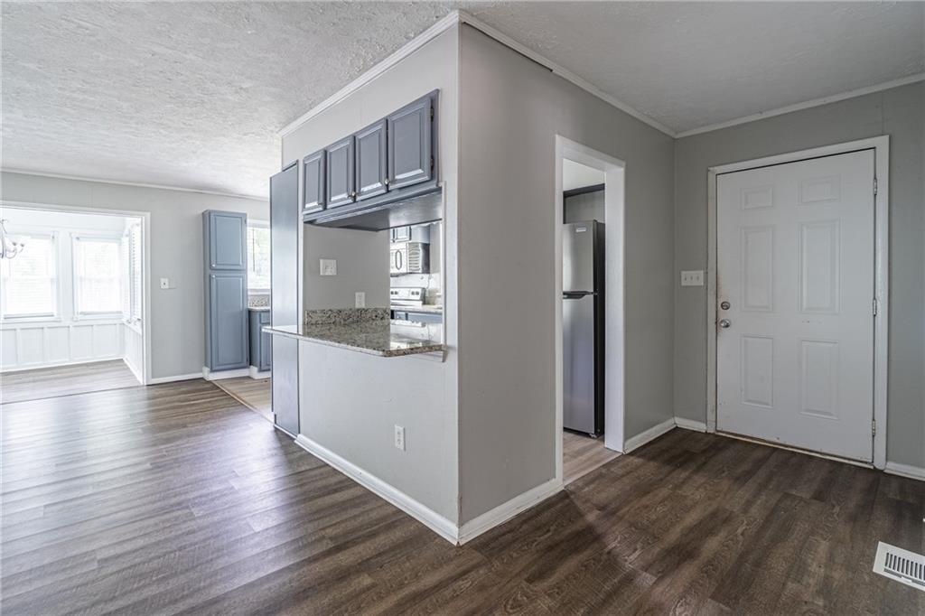 8035 Rockbridge Road Southwest Lithonia, GA 30058 - Photo 8 of 39 an empty room with wooden floor and windows