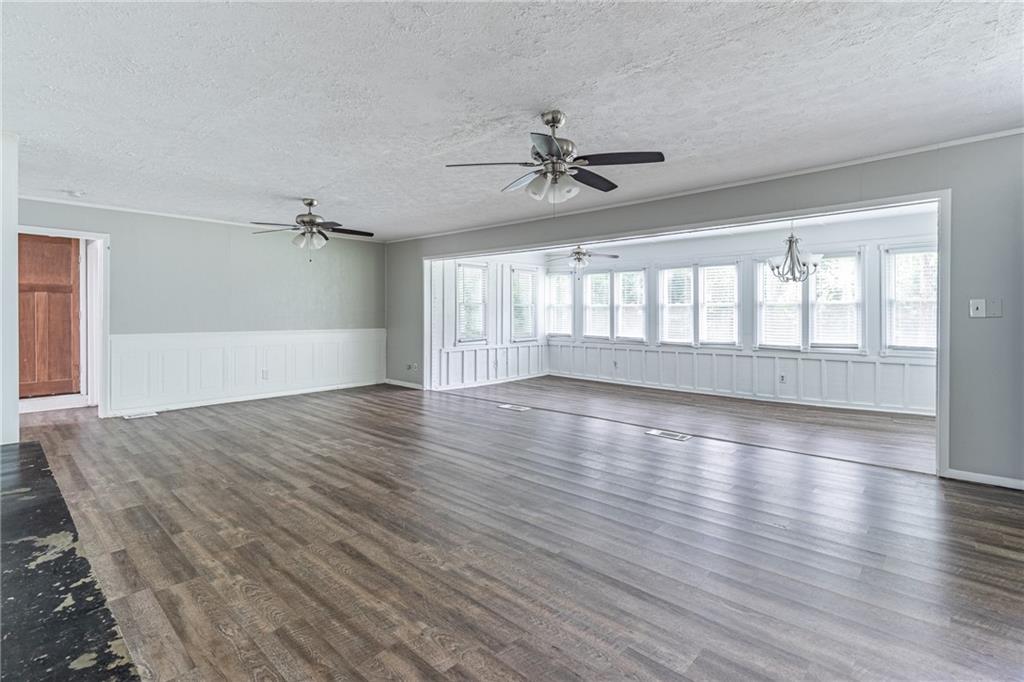 8035 Rockbridge Road Southwest Lithonia, GA 30058 - Photo 9 of 39 a view of an empty room with wooden floor and a window