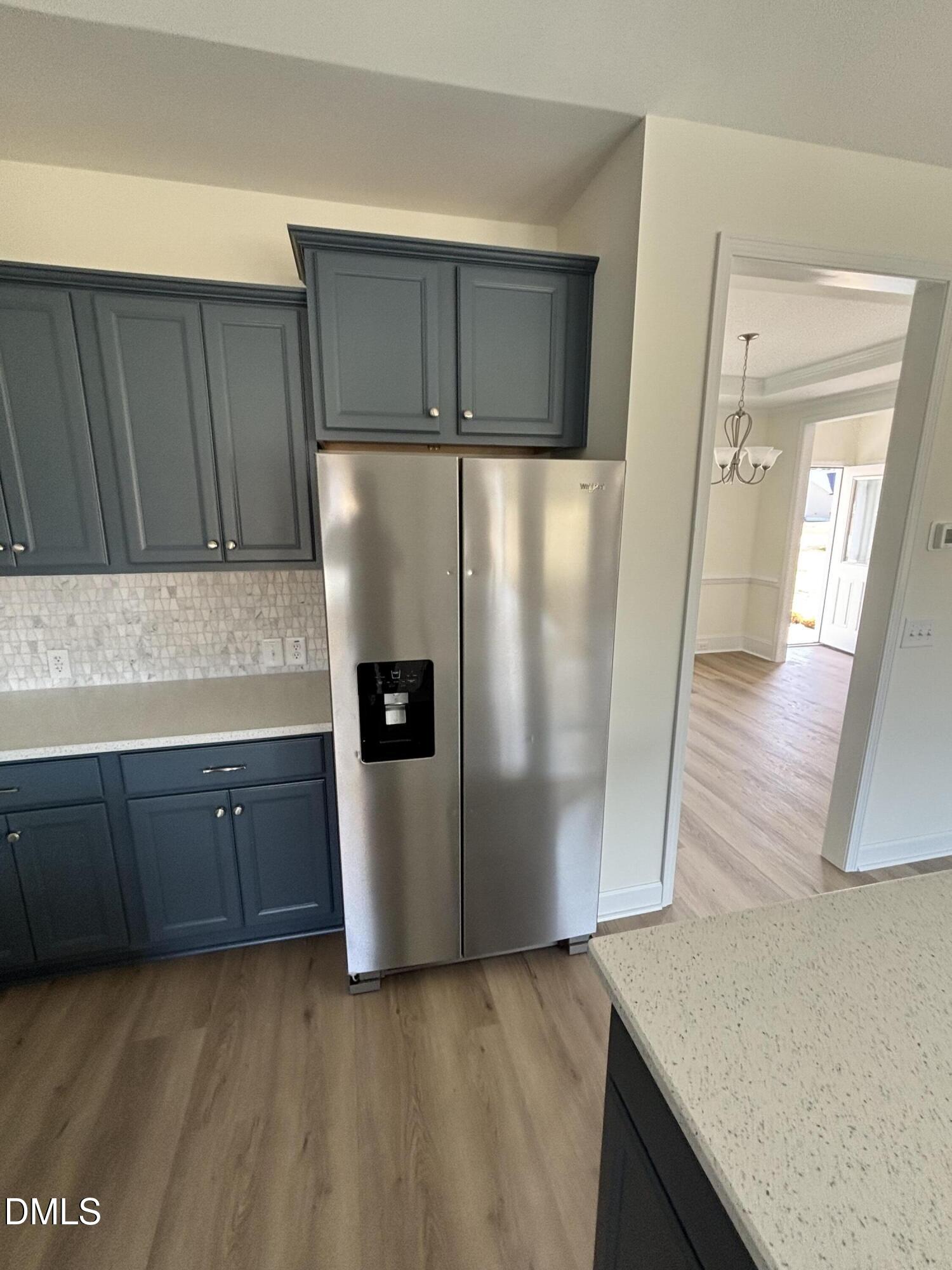 149 Budd Godwin Lane Dunn, NC 28334 - Photo 11 of 19 a kitchen with stainless steel appliances a refrigerator and wooden cabinets