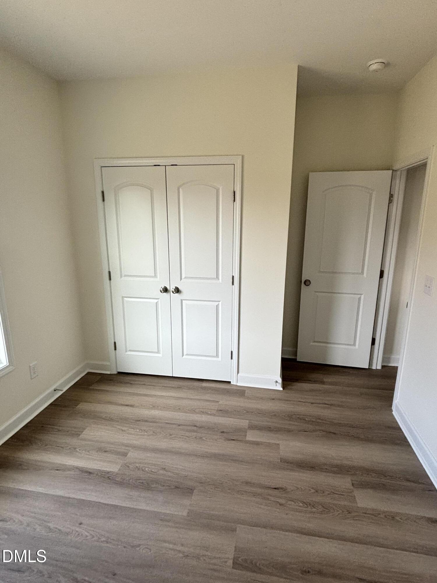 149 Budd Godwin Lane Dunn, NC 28334 - Photo 7 of 19 a view of an empty room with wooden floor