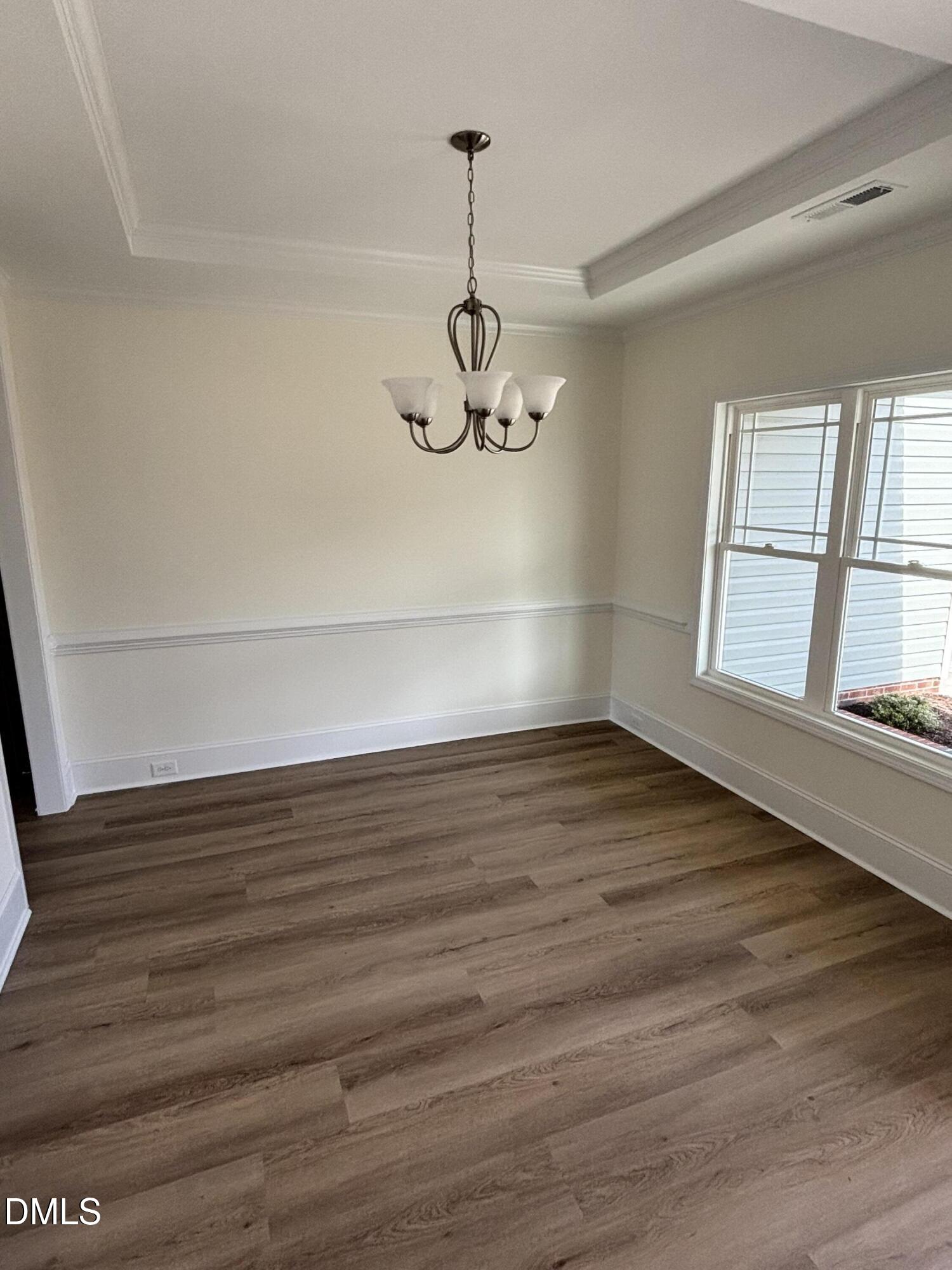 149 Budd Godwin Lane Dunn, NC 28334 - Photo 8 of 19 a view of empty room with wooden floor and window