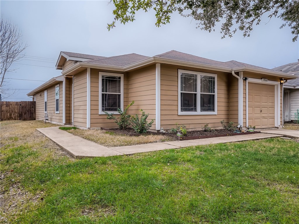 17808 Honey Locust Lane Elgin, TX 78621 - Photo 1 of 1 a front view of a house with yard and green space