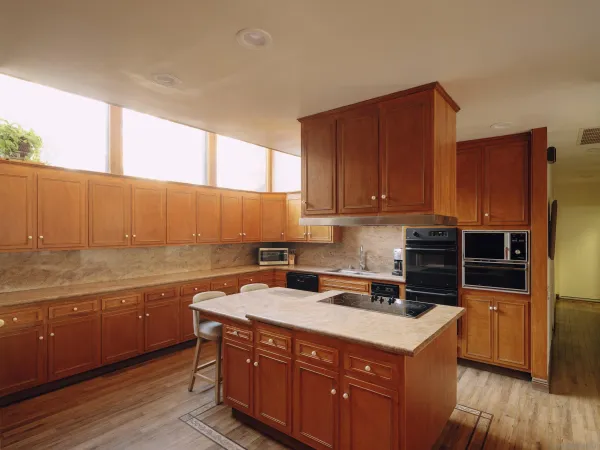 a kitchen with a sink a stove and cabinets