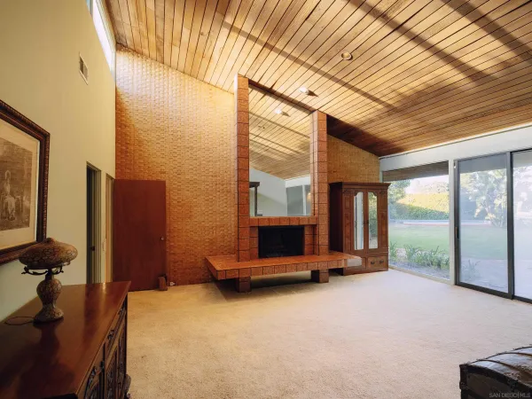 a bedroom with a bed and large windows