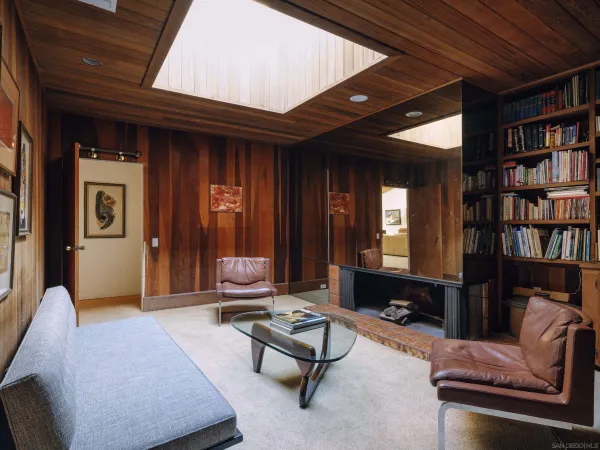 a living room with furniture and a book shelf