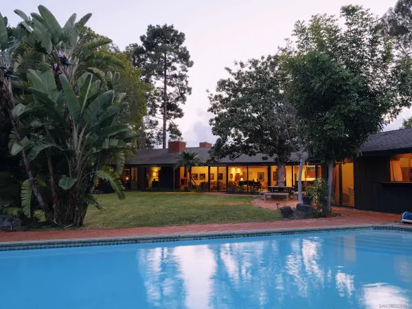 a view of swimming pool and trees in the background