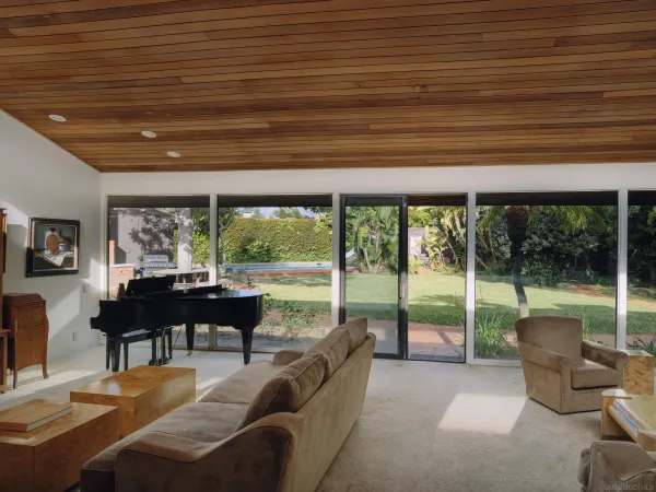 a living room with furniture and a floor to ceiling window