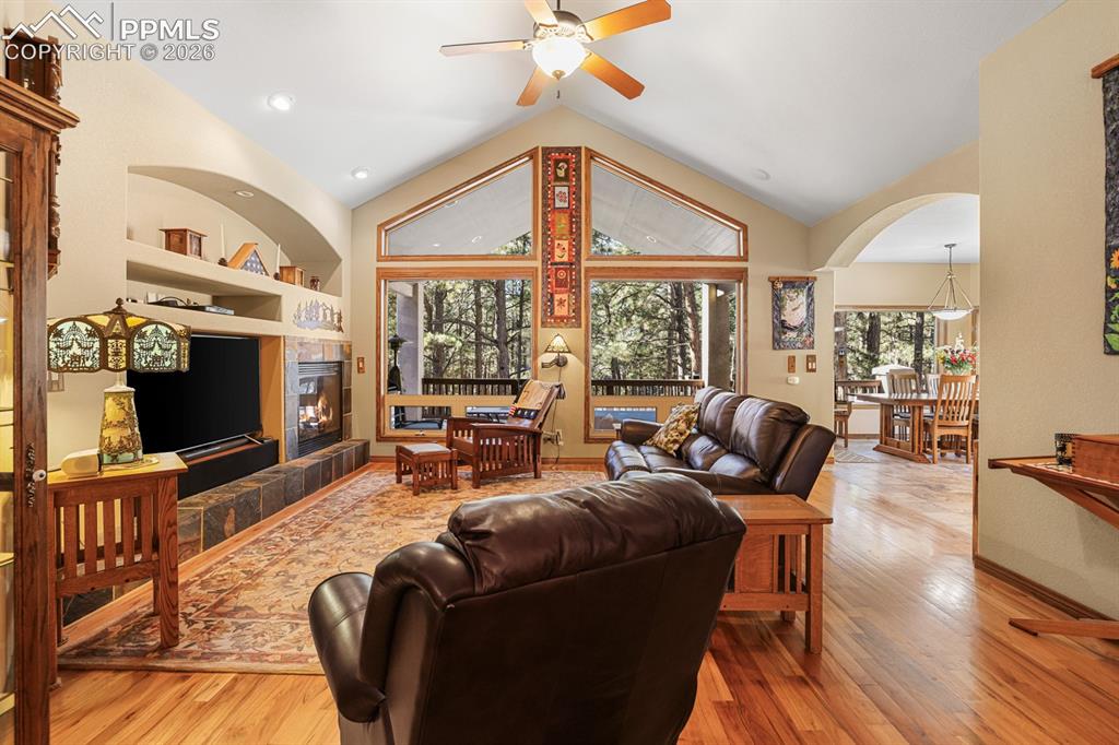 17990 Sawmill Road Colorado Springs, CO 80908 - Photo 9 of 40 Living room with vaulted ceiling and hardwood floor