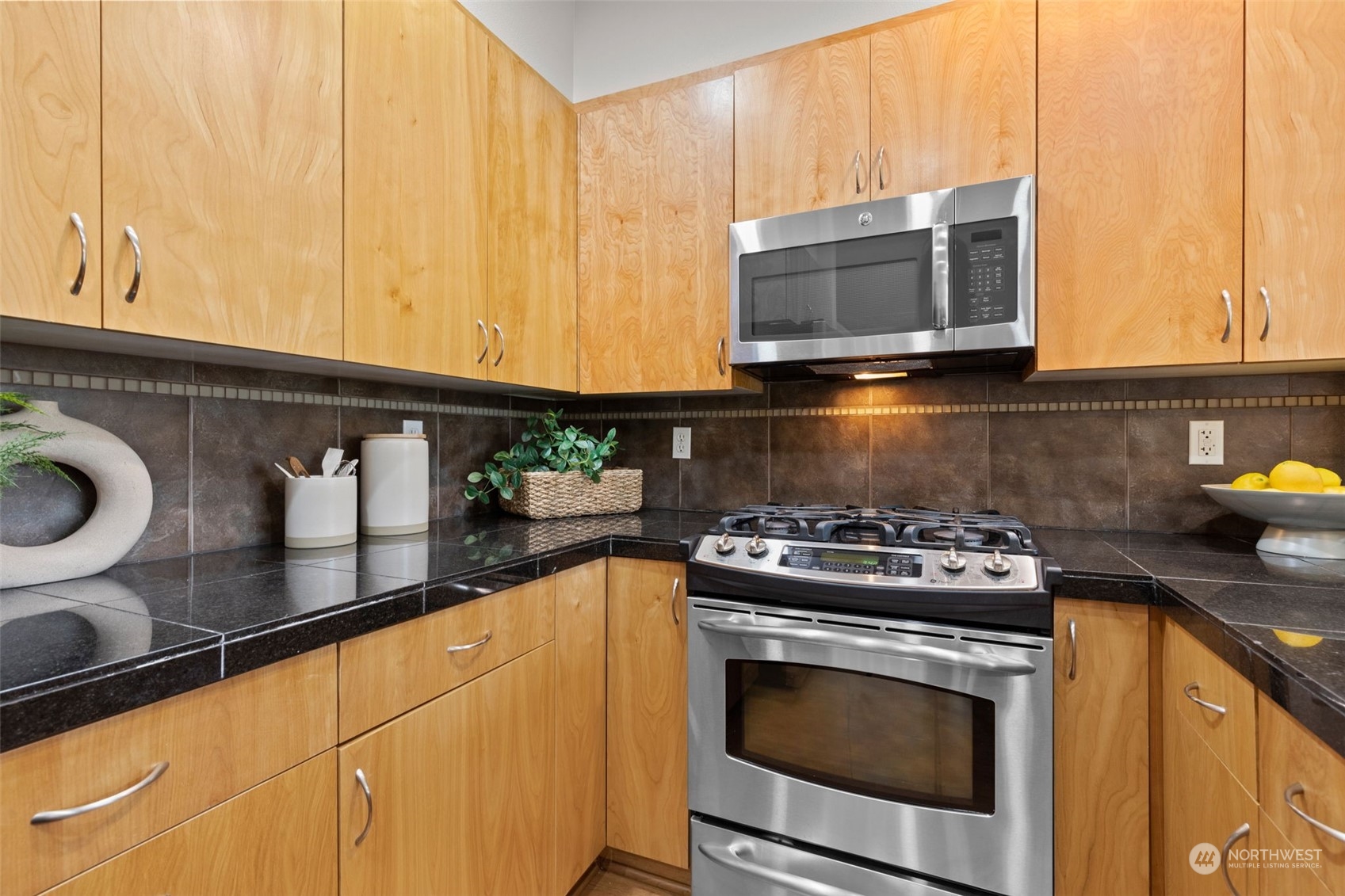 58 Cougar Ridge Road Northwest, Unit 2203 Issaquah, WA 98027 - Photo 13 of 37 a kitchen with stainless steel appliances granite countertop a stove a microwave and oven