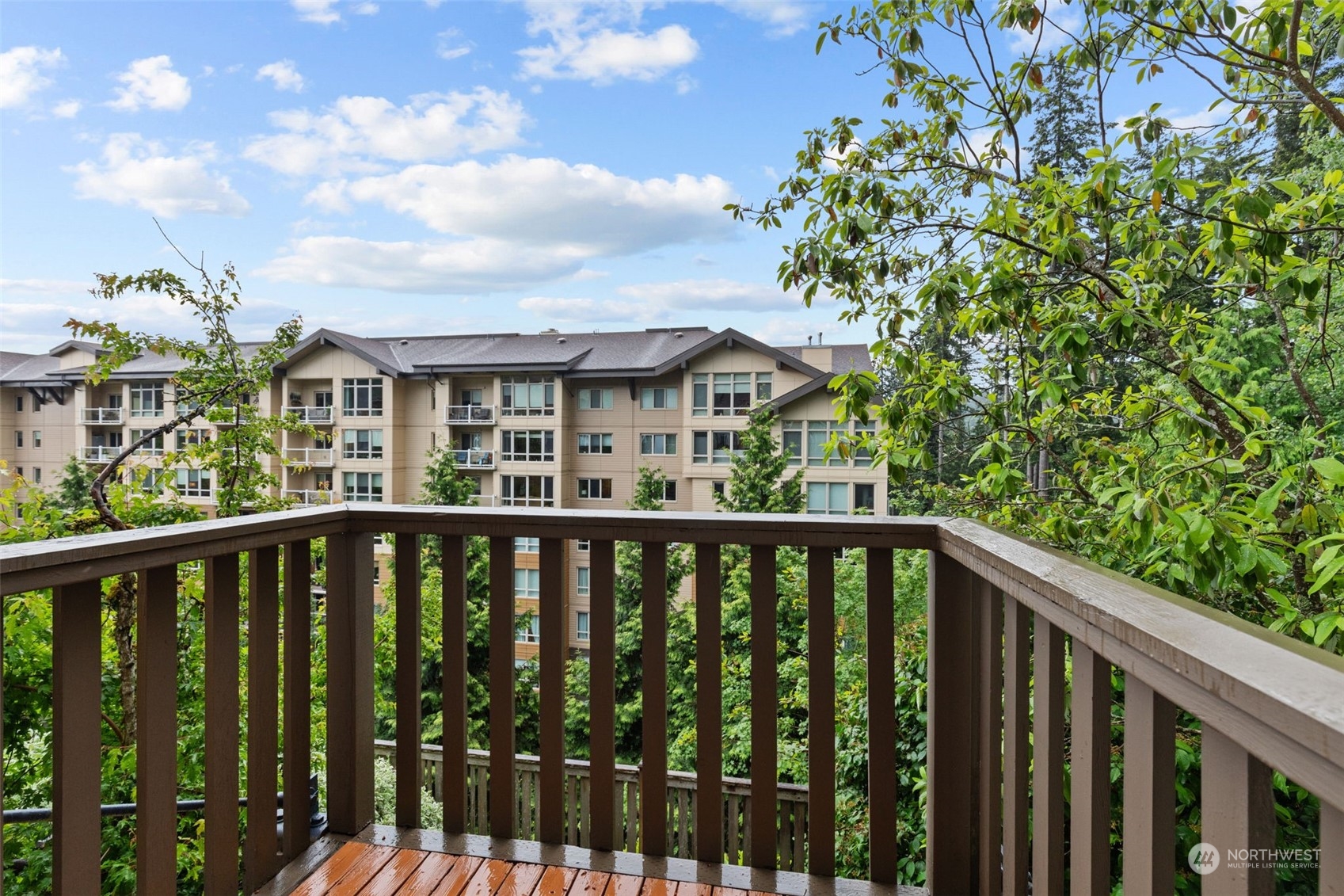 58 Cougar Ridge Road Northwest, Unit 2203 Issaquah, WA 98027 - Photo 14 of 37 a view of a balcony with wooden fence and floor