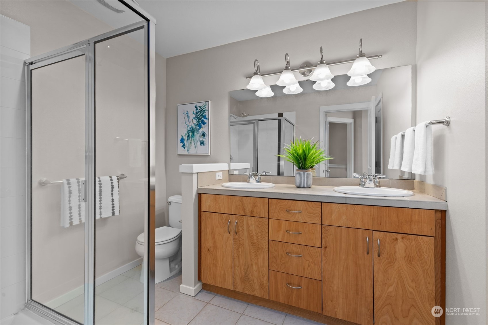 58 Cougar Ridge Road Northwest, Unit 2203 Issaquah, WA 98027 - Photo 23 of 37 a bathroom with a sink and mirror with bathtub