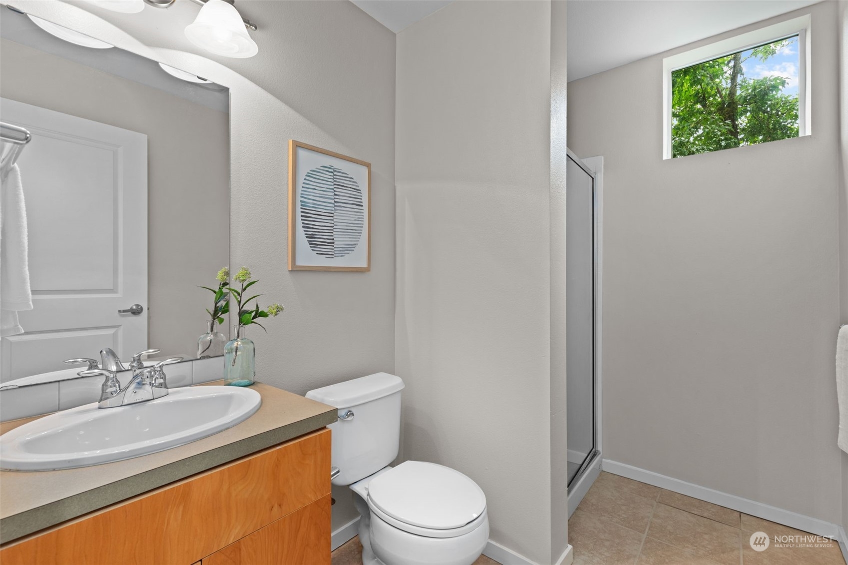 58 Cougar Ridge Road Northwest, Unit 2203 Issaquah, WA 98027 - Photo 26 of 37 a bathroom with a sink a toilet and mirror