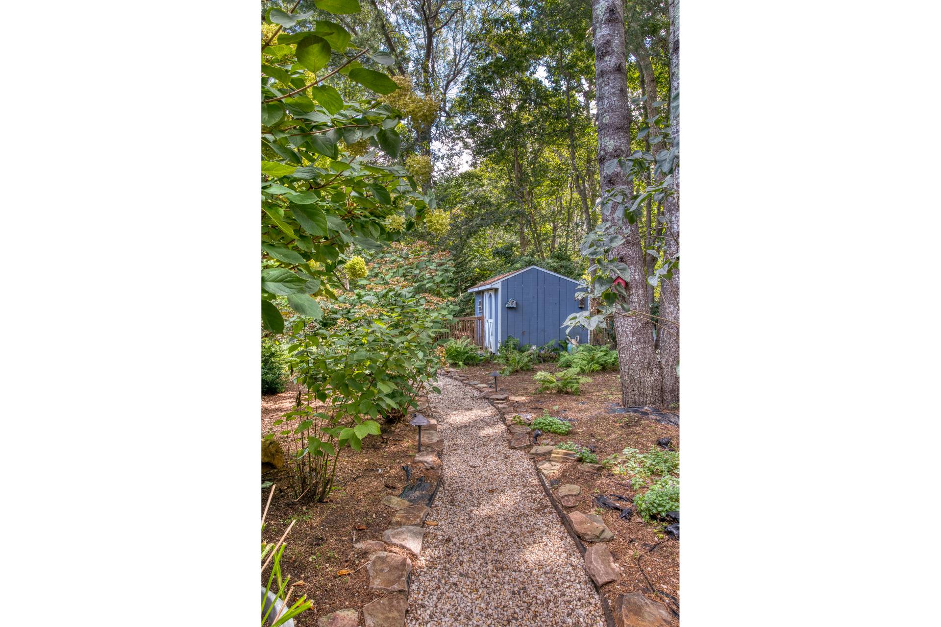 1 Abigails Path East Hampton, NY 11937 - Photo 14 of 18 a picture of a bench in a backyard
