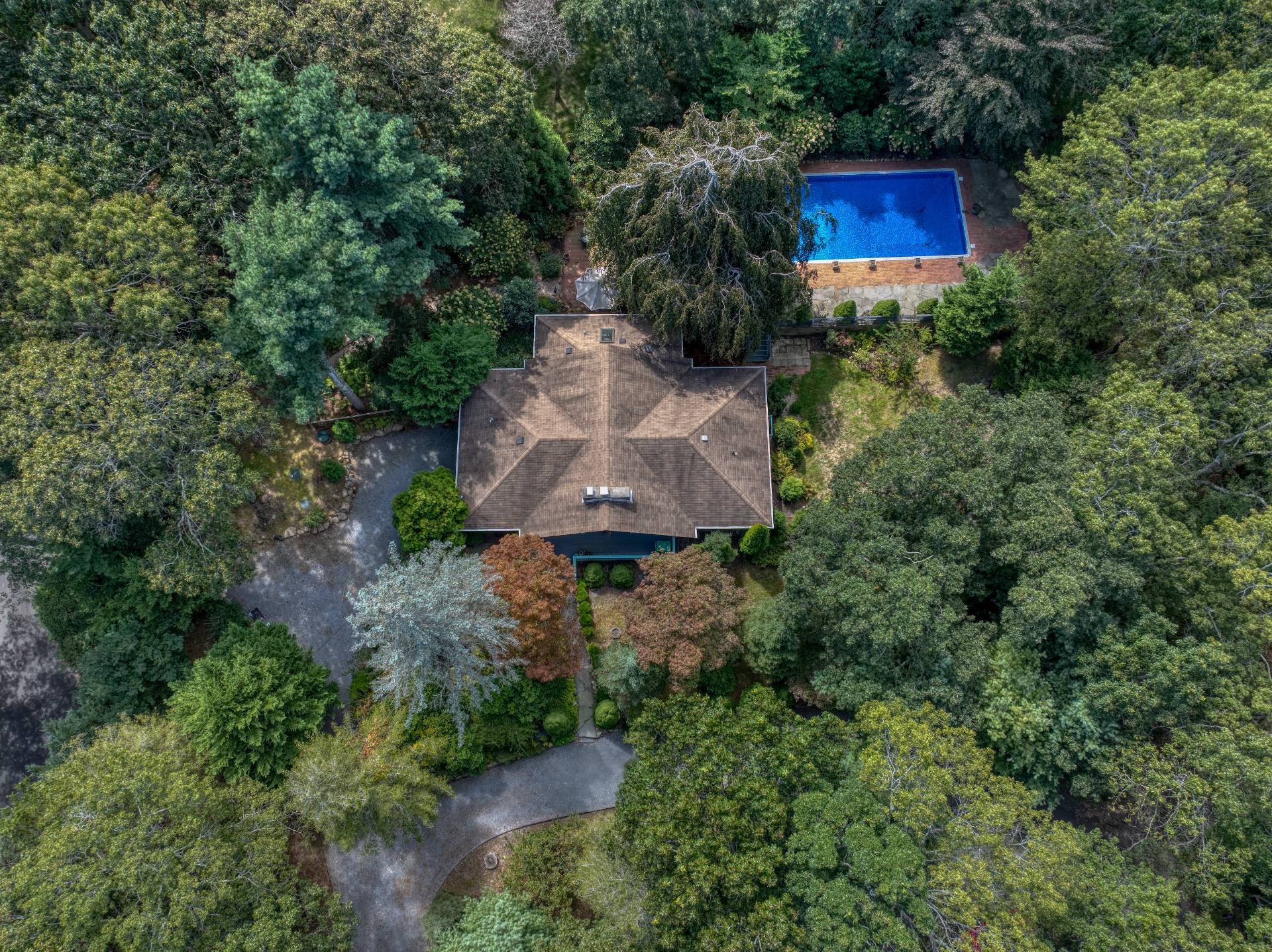 1 Abigails Path East Hampton, NY 11937 - Photo 16 of 18 a aerial view of a house with a yard and trees all around